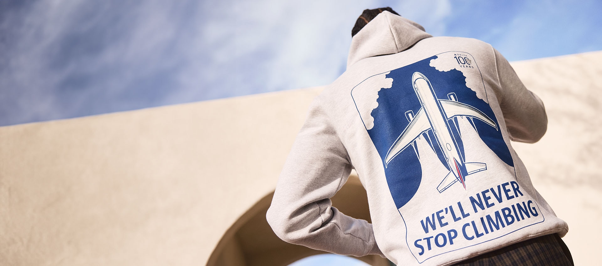 Back of a man wearing a Delta Centennial Hoodie