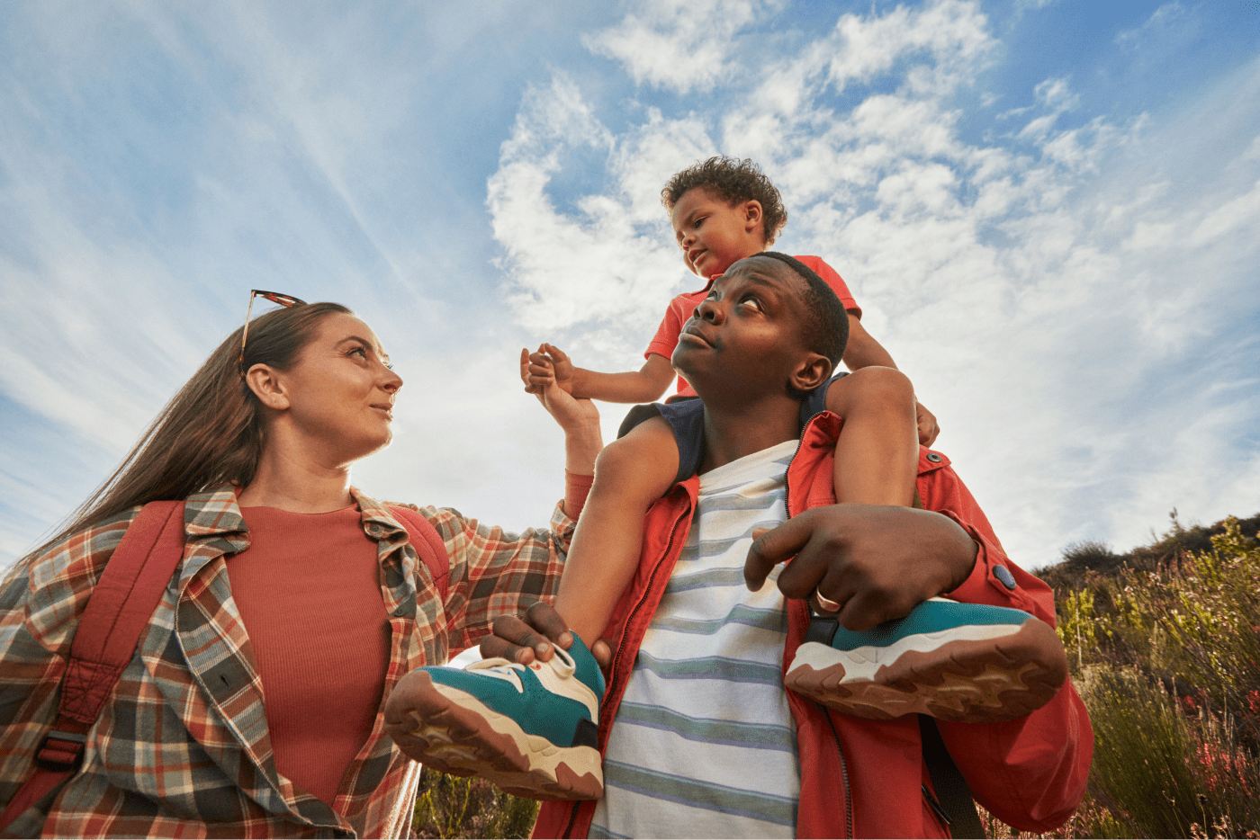 Husband and wife with the child on the shoulder of the husband