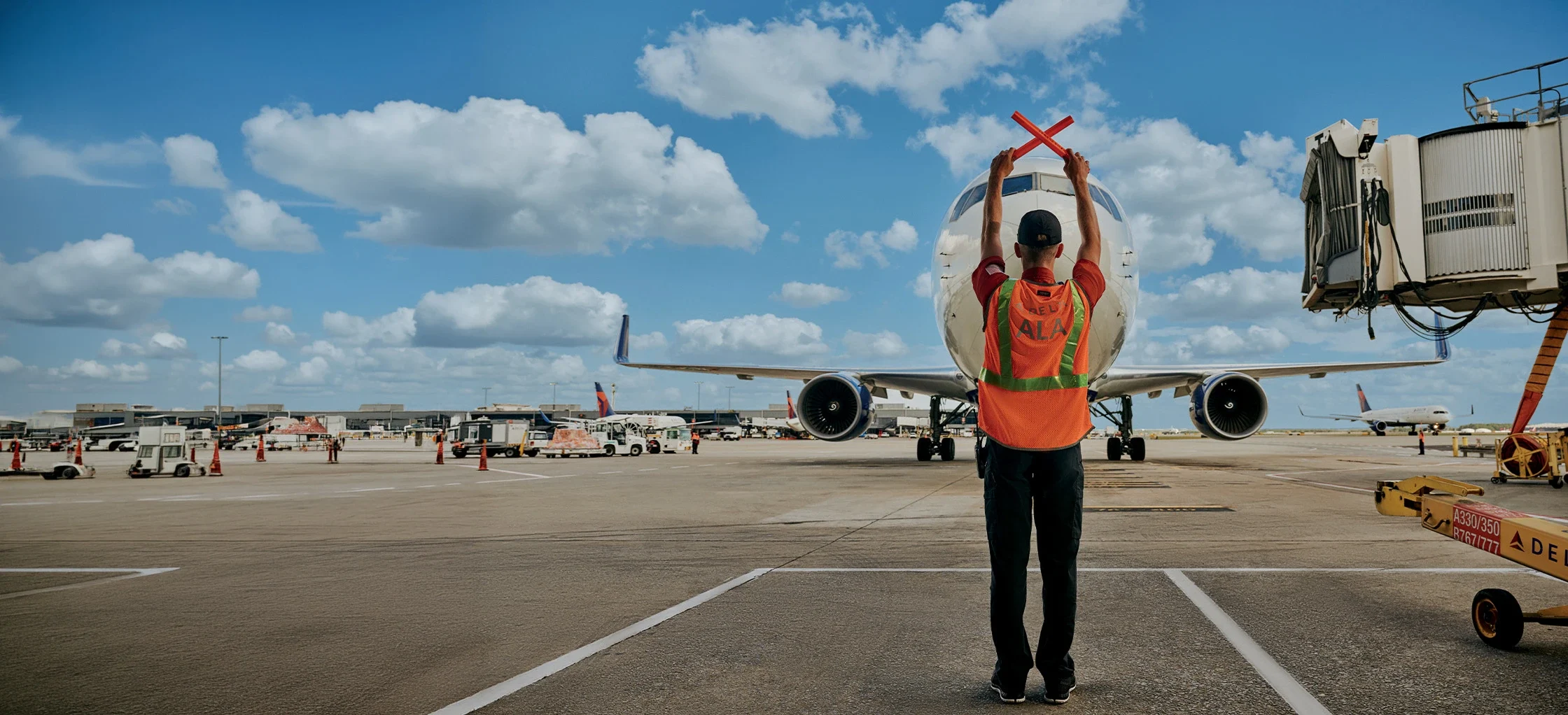 Ground crew guiding airplane on runway
