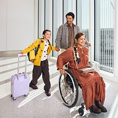 Man, woman, and child walking through airport.