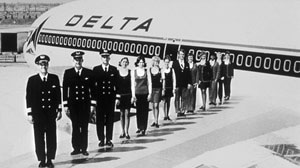 Employees lined up on the wing of a plane