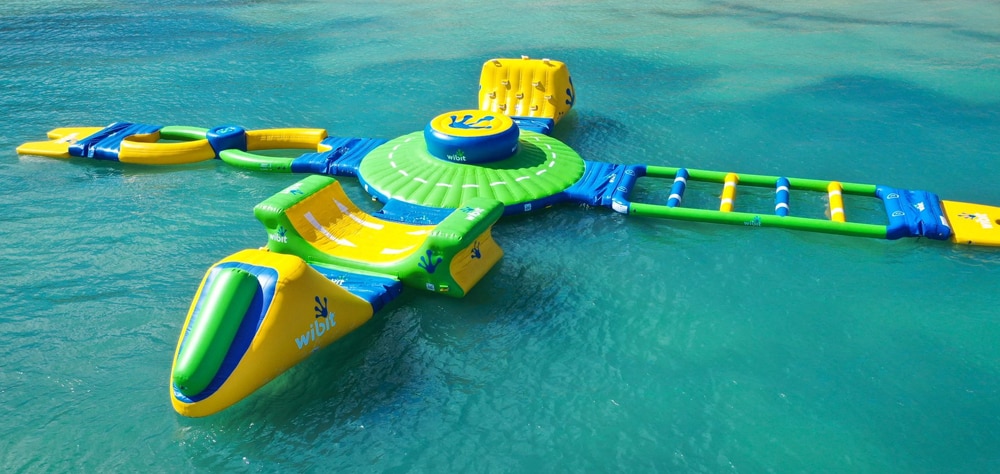 Luxury beachfront resort, Infiniti pool with palm trees, lounge, chairs, and ocean view. 