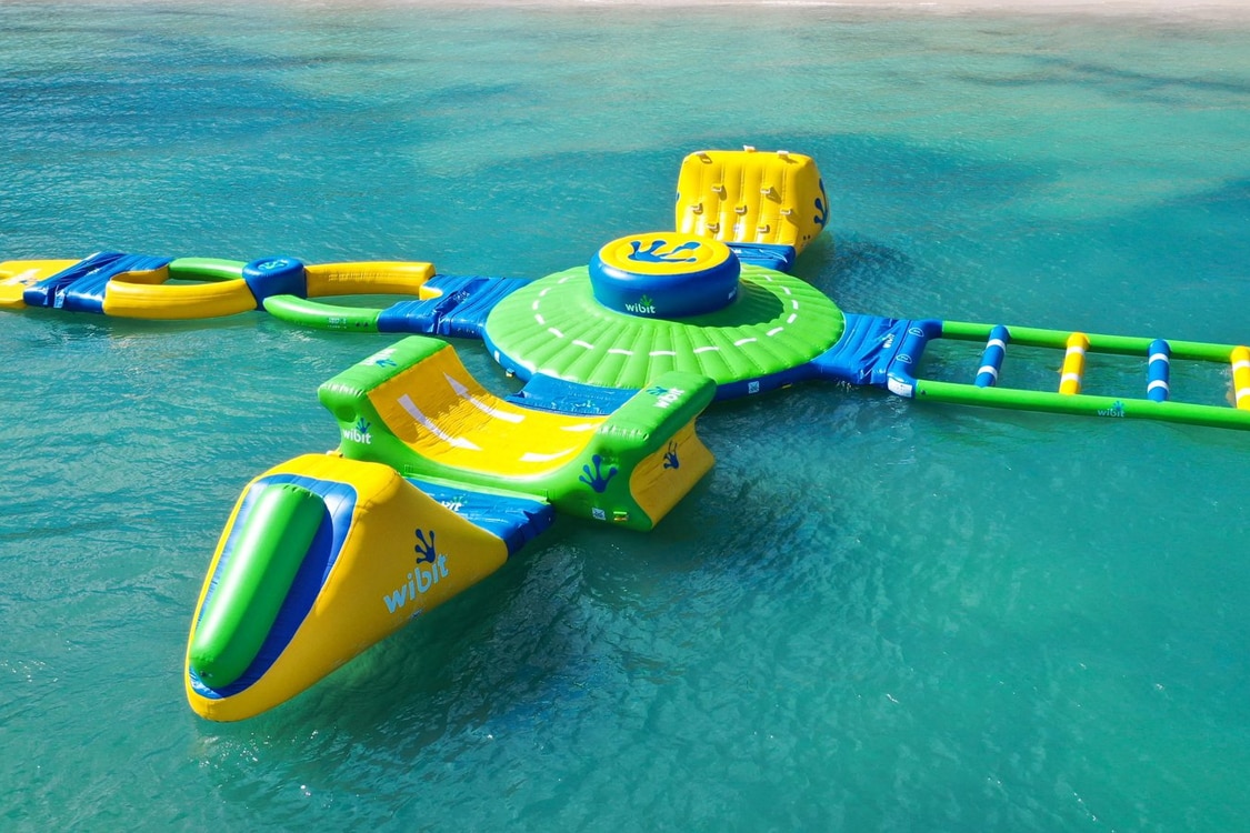 Luxury beachfront resort, Infiniti pool with palm trees, lounge, chairs, and ocean view. 