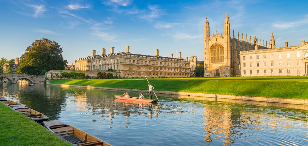 River Cam in Cambridge with traditional punting boats and King's College Chapel in the background. 