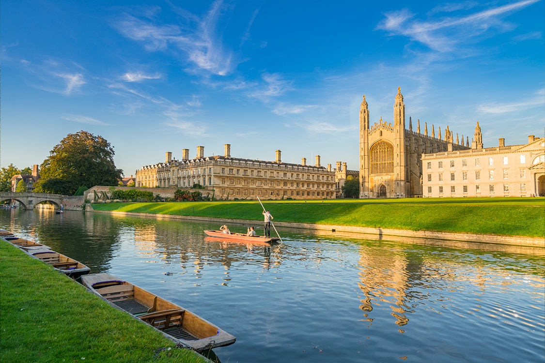 River Cam in Cambridge with traditional punting boats and King's College Chapel in the background. 