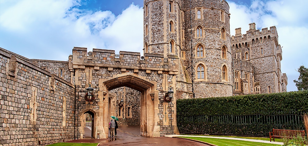 Windsor Castle entrance with medieval stone walls and historic towers in England. 