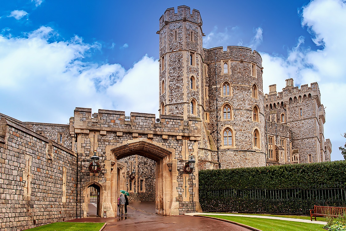 Windsor Castle entrance with medieval stone walls and historic towers in England. 