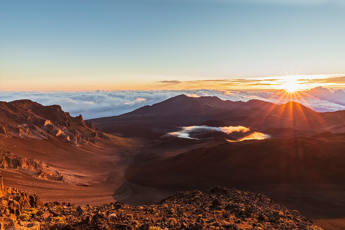 Sunrise over Haleakala crater in Maui with volcanic landscape. 