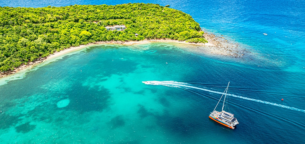 Aerial view of Saona Island with a catamaran and turquoise blue waters. 