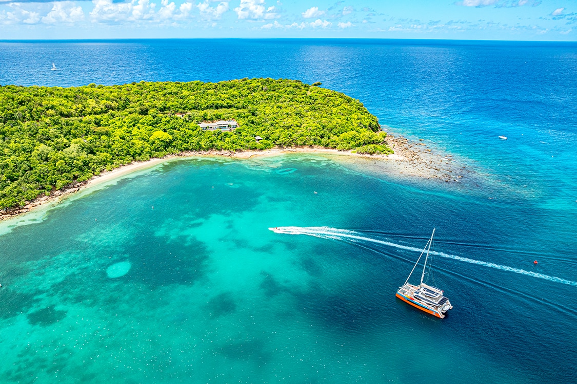 Aerial view of Saona Island with a catamaran and turquoise blue waters. 